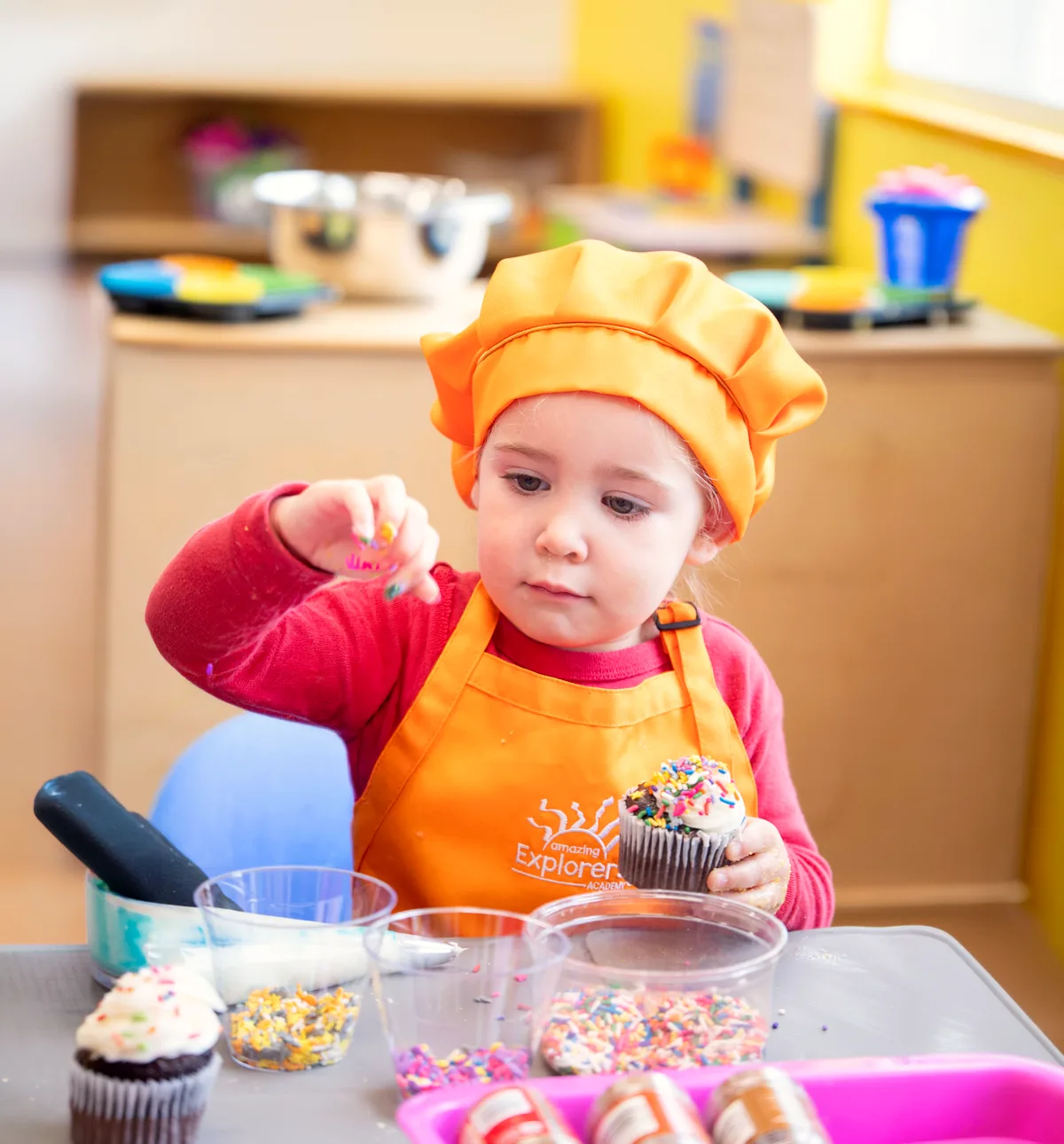 Preschooler measuring ingredients during a hands-on cooking activity