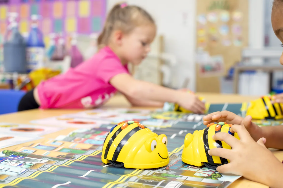 Preschool teacher guiding children through a hands-on STEAM activity