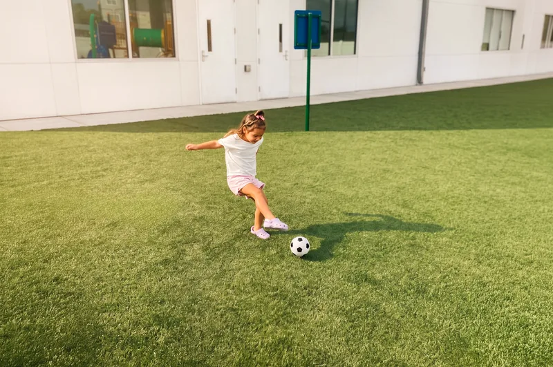 Girl kicking a soccer ball