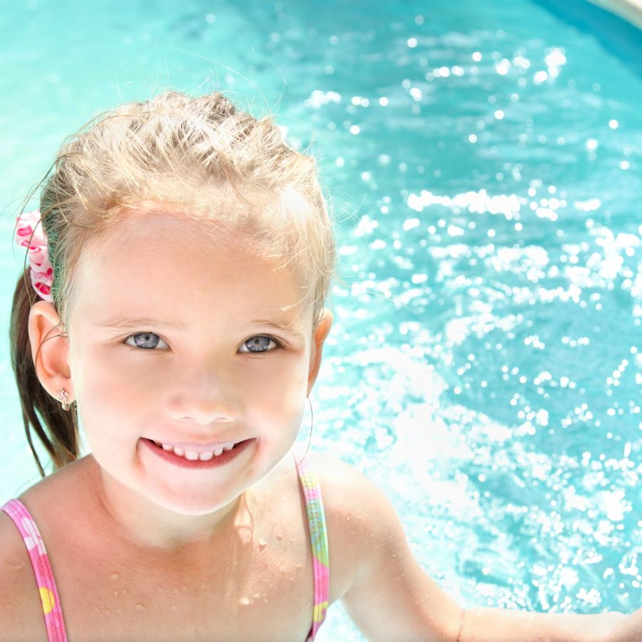 Pretty little girl in swimming pool